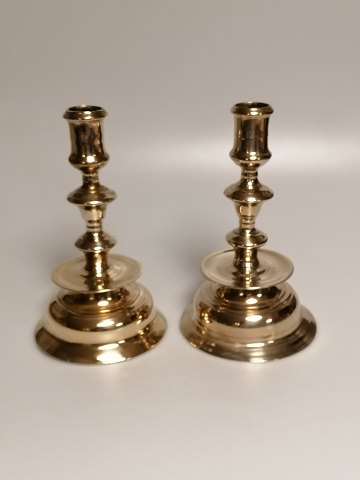 A pair of brass candlesticks at the end of the 
18th century.